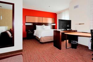 Duży pokój hotelowy z łóżkiem i biurkiem w obiekcie Residence Inn by Marriott Lake Charles w mieście Lake Charles