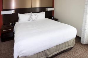 uma grande cama branca num quarto de hotel em Residence Inn by Marriott Lake Charles em Lake Charles