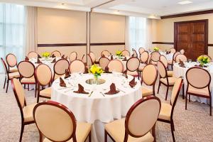 a set of tables and chairs in a room at Sheraton Rockville in Rockville