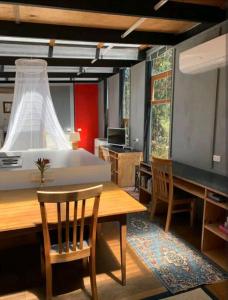 a room with a table and chairs and a bed at Francis Lane Tiny Studio in Adventure Bay