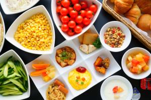 a table topped with bowls of different types of food at Sasebo Washington Hotel in Sasebo