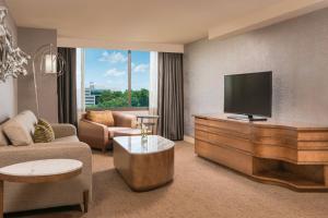 a living room with a flat screen tv and a couch at The Westin Tysons Corner in Tysons Corner