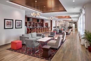 a lobby with chairs and tables and a bar at Four Points by Sheraton Edmonton West in Edmonton