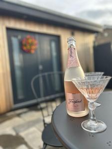 a bottle of champagne and a wine glass on a table at The Studio by Hip Haus in Cleethorpes