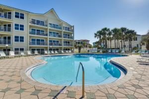 a swimming pool in front of a apartment building at Well-Appointed Family Condo on Miramar Beach! in Destin