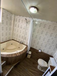 a bathroom with a tub and a toilet and a sink at Hotel Andenes in Arequipa +57 photos
