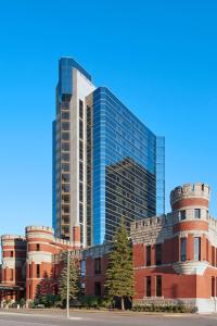 un bâtiment avec un haut gratte-ciel en arrière-plan dans l'établissement Delta Hotels by Marriott London Armouries, à London