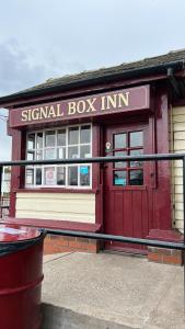 a signal box inn building with a trash can in front at The Studio by Hip Haus in Cleethorpes