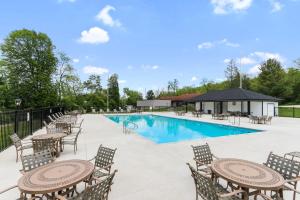 a pool with tables and chairs and a pavilion at YOUR New Luxury Lakeview Condo w Pool Access in Lake Geneva