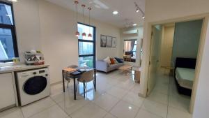 a room with a kitchen and a living room at Arte Mont Kiara by Autumn Suites Premium Stay in Kuala Lumpur