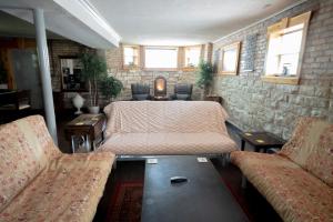a room with a bed and a couch and chairs at Inspiring Grotto Sleeps 10-20 Free TV & Parking in Chicago