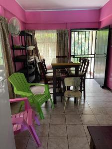 a dining room with colorful chairs and a table at Casa vacacional Morales in Puntarenas