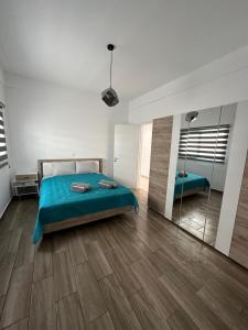 a bedroom with a bed and a mirror at Villa Meropi in Paphos