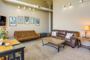 a living room with leather couches and a table at Waterfront Sandusky Vacation Rental Downtown! in Sandusky