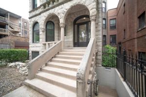 a stone building with stairs leading to a doorway at Inspiring Grotto Sleeps 10-20 Free TV & Parking in Chicago