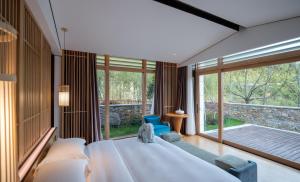 a bedroom with a large bed and a large window at G-Luxe by Gloria Taimei Suzhou in Suzhou