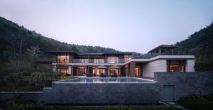 a house in the mountains with a swimming pool at G-Luxe by Gloria Taimei Suzhou in Suzhou