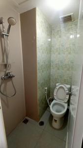 a bathroom with a toilet in a shower stall at RB Room Bogorienze The Jungle Bogor in Bogor
