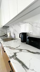 a kitchen with a marble counter top with a toaster at Beach House Holiday in Neoi Epivates