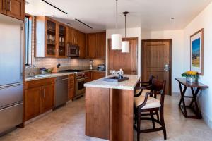 a kitchen with wooden cabinets and a island with a counter top at The Ritz-Carlton, Rancho Mirage in Rancho Mirage