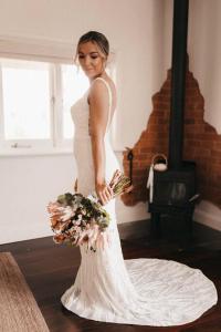 a woman in a white wedding dress holding a bouquet at Laurant's Cottage ~ McLaren Vale entertainer in McLaren Vale +27 photos