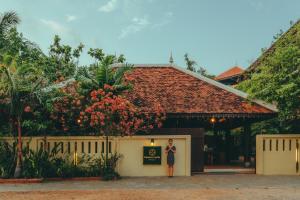 a woman standing in front of a building at Pandora Suite D'Angkor in Siem Reap