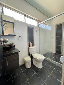 uma casa de banho com um WC e uma cabina de duche em vidro. em Apartamento en Coveñas cerca al mar #204 em Coveñas