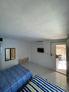 a bedroom with two beds and a window with a motorcycle at Casa Nova! PRIVATE BATHROOM AND ROOM in Cancún