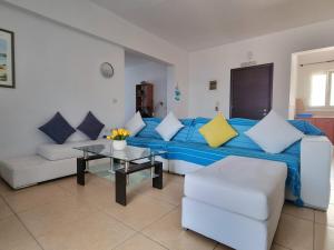 a living room with a couch and a table at Zafeiris Apartments in Livadia