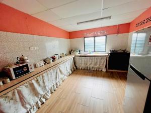 a kitchen with a table with curtains on it at Halim's Rumah Singgah Mxslim only in Jelutong