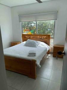 a bedroom with a bed and a large window at Apartamento en coveñas cerca al mar #202 in Coveñas