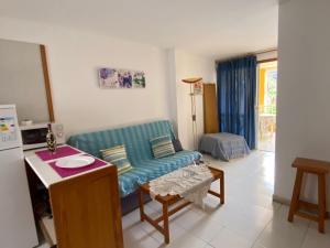 a living room with a couch and a table at Tazacortes Beach and also Luz y Mar apartments in Puerto