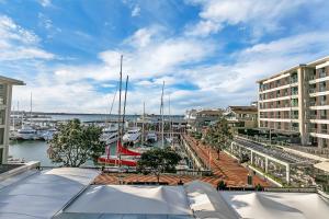 a marina with boats in the water and buildings at Sunset Harbour Sanctuary + CP in Auckland