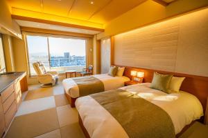 Postel nebo postele na pokoji v ubytování Dogo Prince Hotel