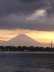 a mountain in the distance with a sunset in the background at La Bohème in Gili Air