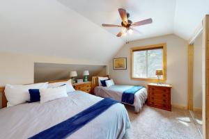 a bedroom with two beds and a ceiling fan at Pine Lantern Retreat in South Lake Tahoe