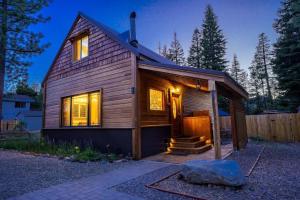 a small wooden house with lights on at Pine Lantern Retreat in South Lake Tahoe