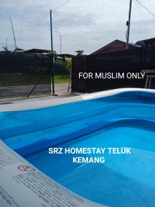 a sign for a swimming pool with the words srk homesay tooling at Srz Homestay Teluk Kemang PD in Port Dickson