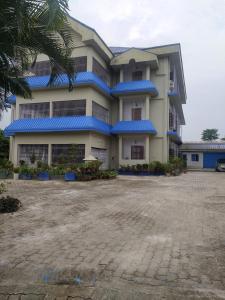 a large building with blue roof at The Camellia in Dibrugarh