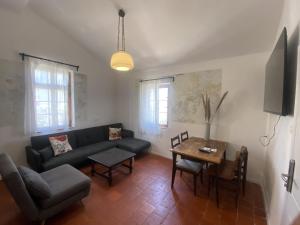 a living room with a couch and a table at Haifa Vintage Studios in Haifa