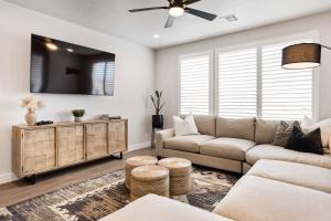 a living room with a couch and a ceiling fan at Desert Daydream townhouse in St. George