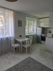 a kitchen with a table and chairs in a room at Comfort in Daugavpils