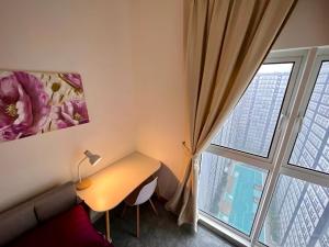a room with a desk and a large window at The Heim in Kajang