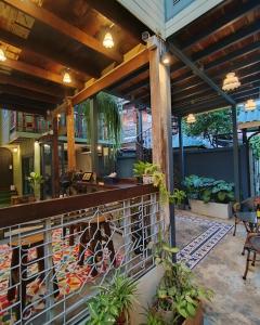 a patio with a fence and some plants at Priya Boutique House in Bangkok