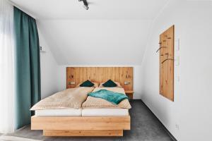 a bedroom with a bed with a wooden headboard at Gästehaus Bosch in Herrenberg