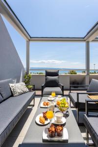 a patio with a table with food on it at Apartments Blue Maris Žnjan in Split