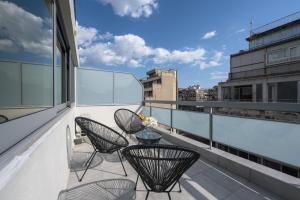 a balcony with chairs and a table on a building at #Luxlikehome Lux Locals 1 in Thessaloniki