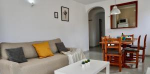 a living room with a couch and a table at Viviendas Margarita II in Colònia de Sant Jordi