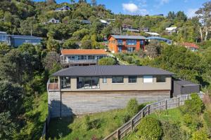 a house on the side of a hill at Blue Water Views in Nelson