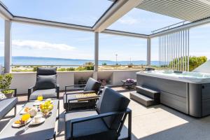 a living room with a view of the ocean at Apartments Blue Maris Žnjan in Split